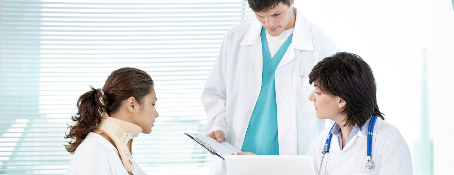 Accident victim in neck brace with two doctors