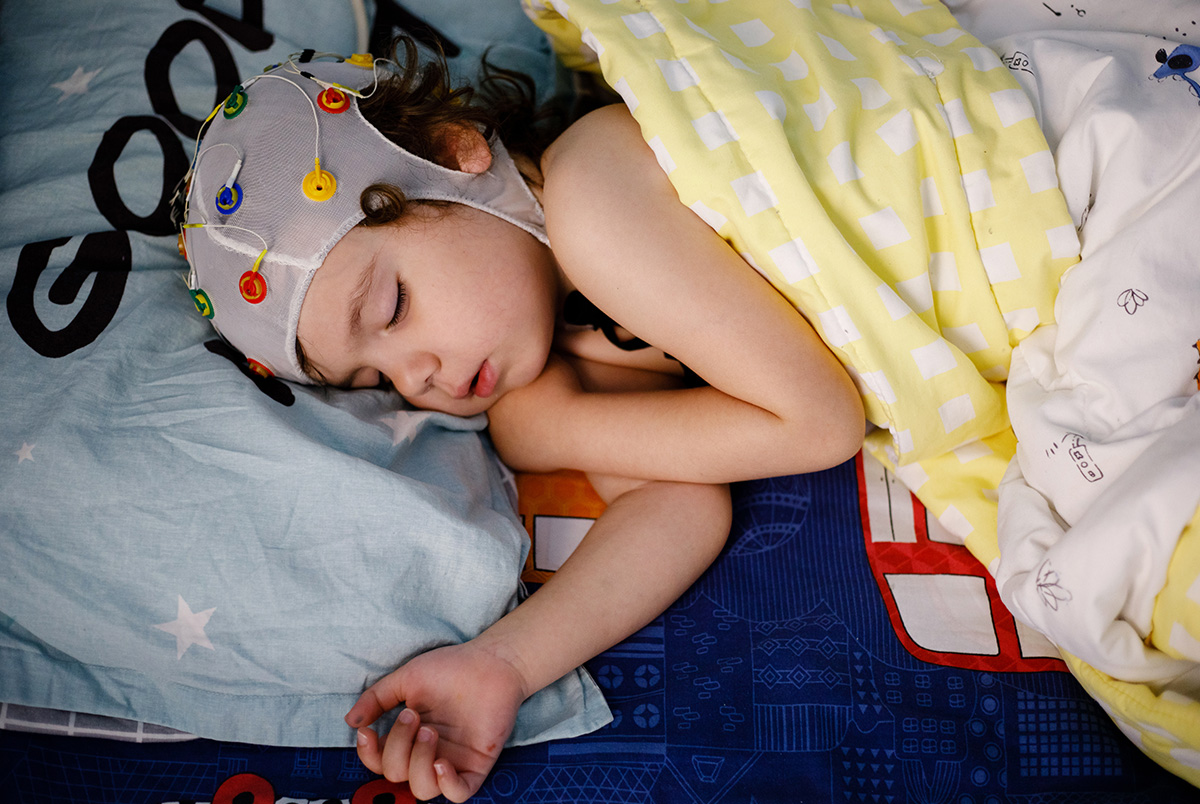 EEG, electroencephalography procedure, encephalography of a small boy in a dream for Brain Injury Awareness Month