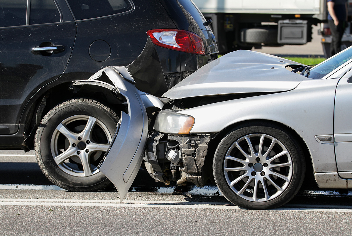 A rear-end collision between a black SUV and a silver car as an example of common types of car accidents.